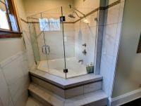 Walk in tub with glass walls and door