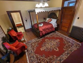 Queen bed, rug, chairs, light fixture