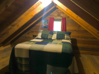 Upstairs loft has a double bed and a twin bed