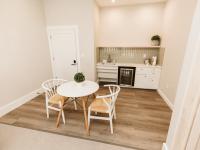 Image shows Kitchenette with Table & Chairs, Sink, Mini Fridge